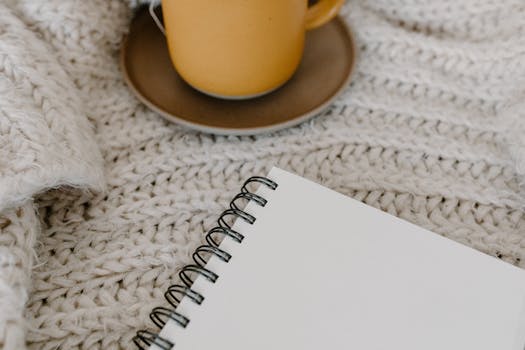 A cozy workspace with a journal and a cup of coffee