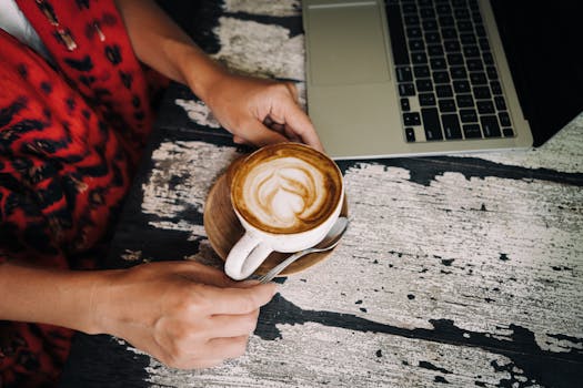 working on a laptop in a cozy coffee shop