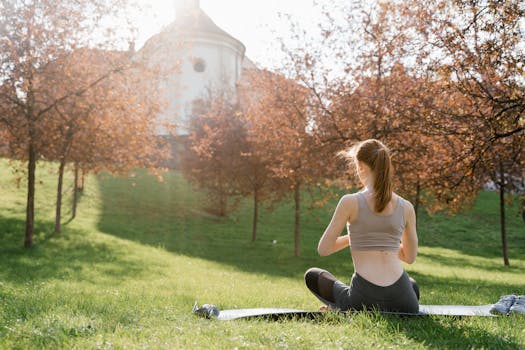 person meditating in a park