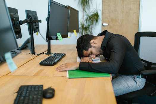 Image of a tired remote worker at a desk